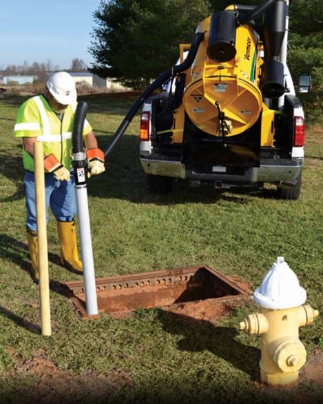 MATECO worker using vacuum excavation tools for private utility locate services