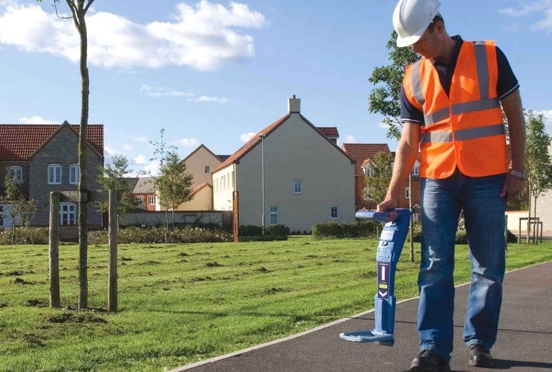 Mateco worker in orange construction vest and hat using an RD7000+ locator